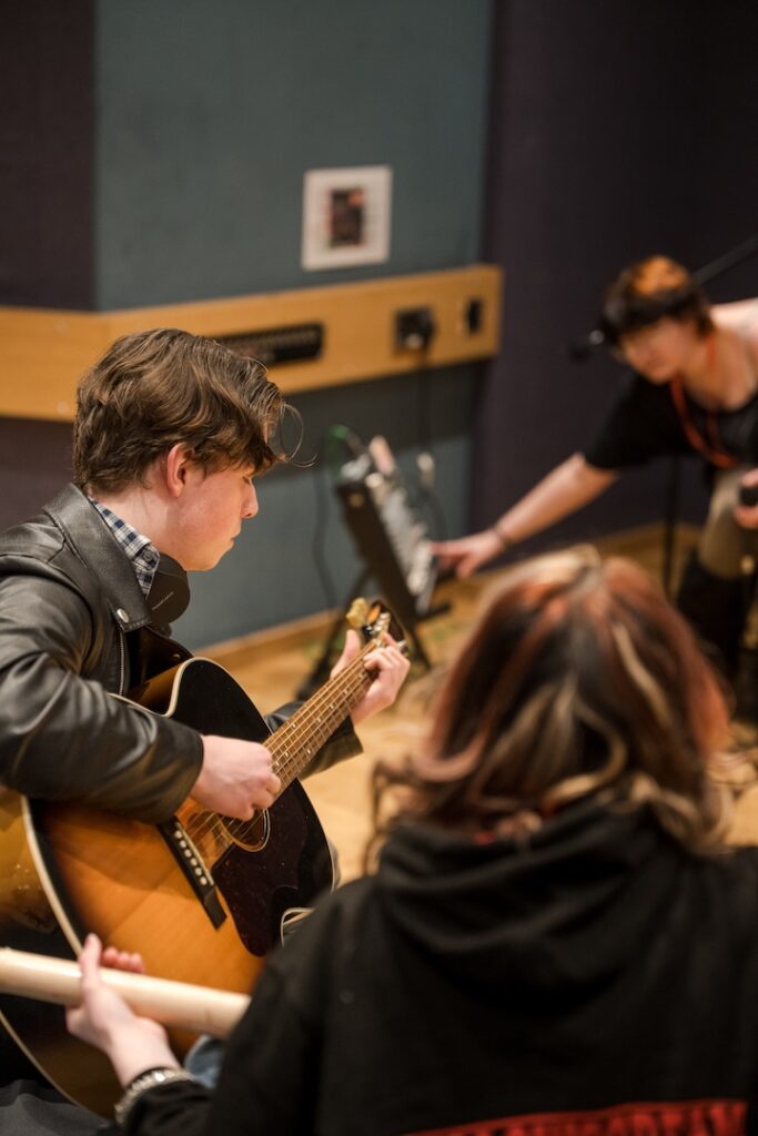 Students doing a practice/warmup for a gig