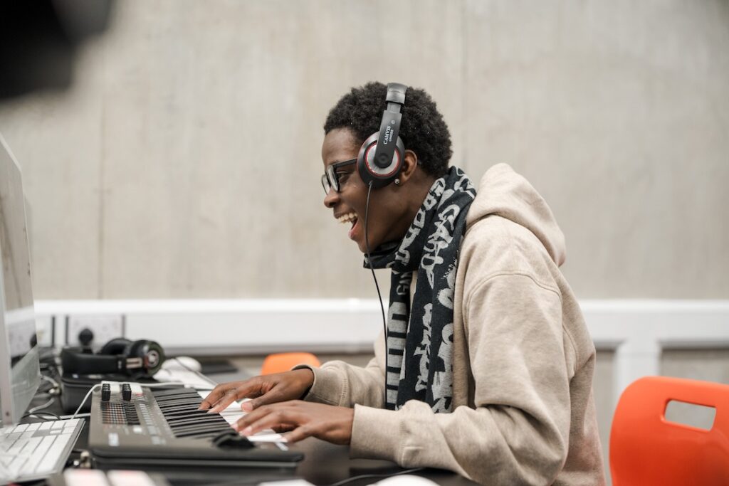 Student in the music mac labs recording some keys