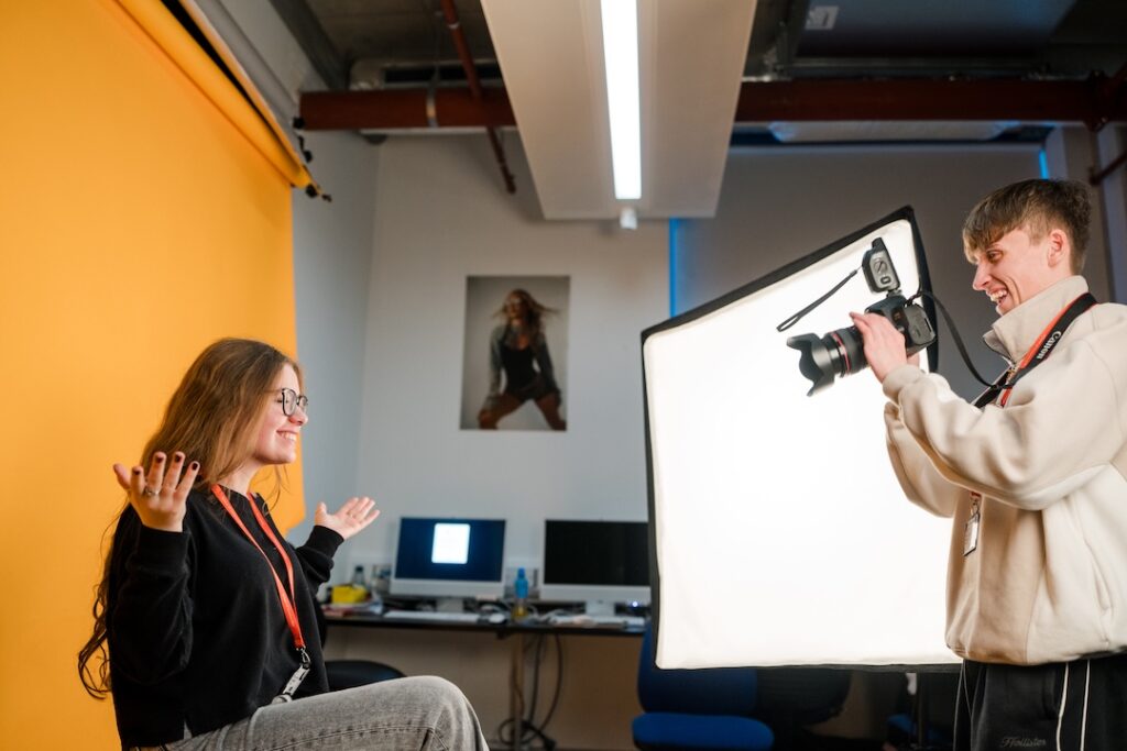Students using a studio setup to take portrait photos