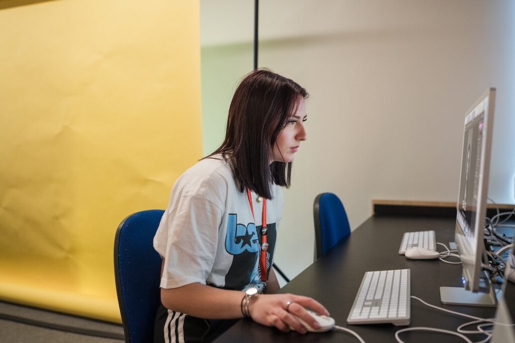 Student editing photos on lightroom